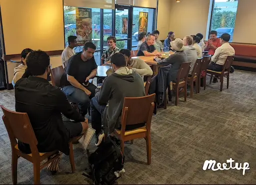 Small group conversations at a weekly GenAI Meetup gathering
